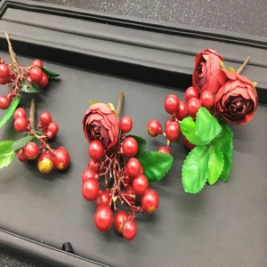 Handmade red fabric roses and berry hair accessories with green leaves for brides