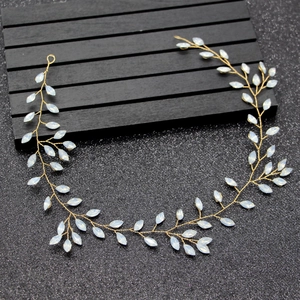 Detail of handcrafted gold wire bridal headband with opal-like resin marquise leaves