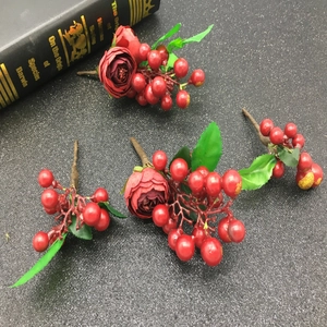 Floral hair accessories with red roses, berries and green leaves for bridal hair styling