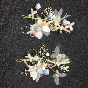 Elegant light blue and white floral hair clips with pearls and fabric butterflies