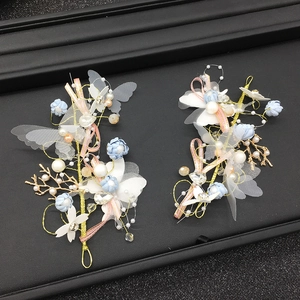 Exquisite handmade bridal hair clips with fabric flowers and delicate butterfly wings