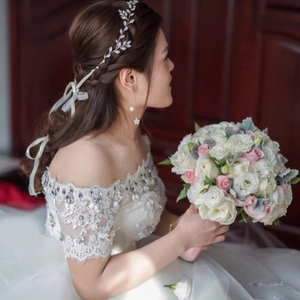 Detail of bridal vine headband with white leaves and matching long pearl earrings