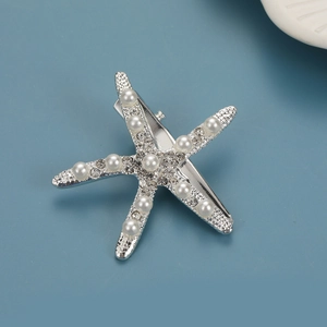 Detail of silver starfish hair clip with white pearls and sparkling rhinestones