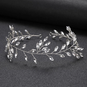 Detail of silver leaf bridal headband with marquise crystals on a black background