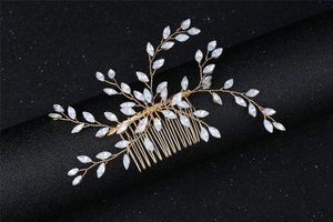 Macro detail of handmade gold wire hair comb with marquise opal stones for bridal styling