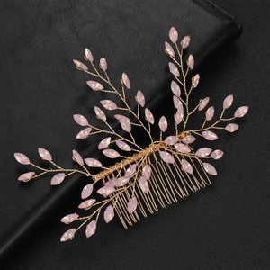 Detailed close-up of handmade golden branch hair comb with pink marquise crystals