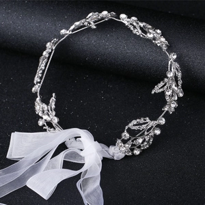 Elegant bridal rhinestone headband with silver leaf design and white organza ribbons