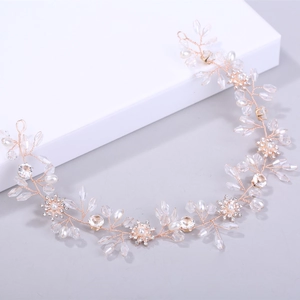 Detail of rose gold bridal hair vine with crystals, faux pearls and rhinestone flowers