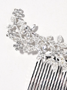 Macro shot of silver bridal hair comb with crystal flowers and leaf rhinestones