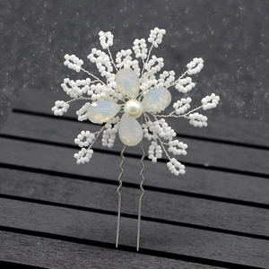 Detail of bridal hair pin with handcrafted beaded flower petals and opal stones