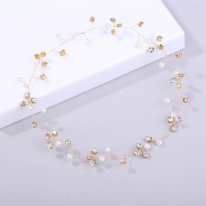 Exquisite gold bridal hair vine with white pearls and sparkling rhinestones for weddings