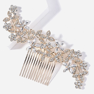 Detail of bridal hair comb with gold floral patterns and sparkling rhinestones