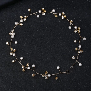 Elegant bridal hair vine with white pearls and sparkling rhinestones on golden wire