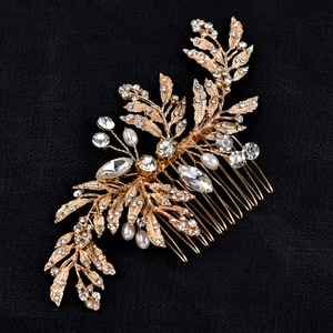 Detail of gold leaf bridal hair comb with white pearls and sparkling rhinestones