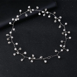 Elegant bridal hairband with white pearls and sparkling rhinestones on silver wire