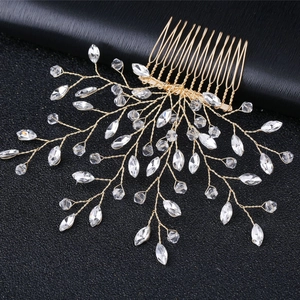 Detailed close-up of handmade bridal hair comb with gold wire and clear crystals