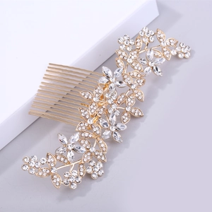 Close-up of elegant gold bridal hair comb with shimmering white rhinestones in floral design