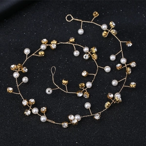 Detail view of pearl and rhinestone bridal hair vine with golden wire branches