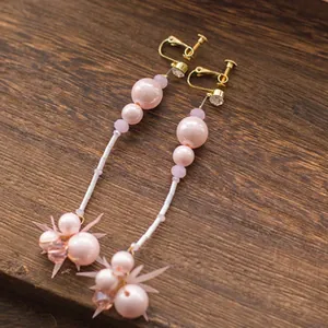 Pink pearl bridal clip-on earrings with long tassels and crystal accents for weddings