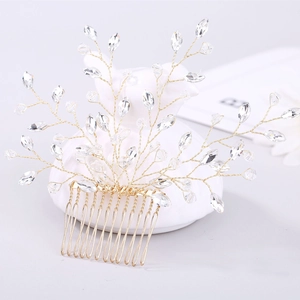 Detail of handcrafted bridal hair comb with gold wire branches and clear crystals