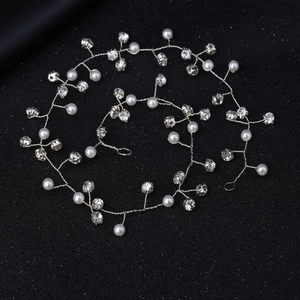 Detailed macro view of silver bridal hair vine with white pearls and sparkling rhinestones