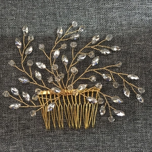 Detail of handmade gold bridal hair comb with crystal branches and clear glass beads