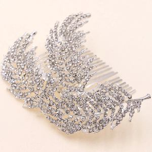 Detailed shot of silver leaf hair comb with sparkling rhinestones on plain background
