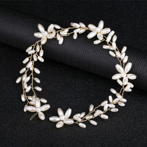 Elegant floral pearl bridal headpiece crafted with gold wire and lustrous white pearls