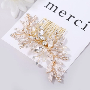 Detail of bridal hair comb with gold leaf motifs, crystals, and white pearls on card