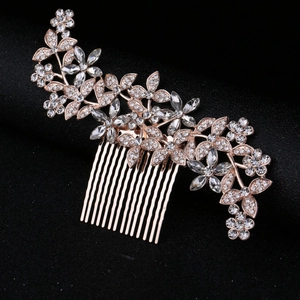 Macro detail of rose gold bridal hair comb featuring leaf design and brilliant rhinestones