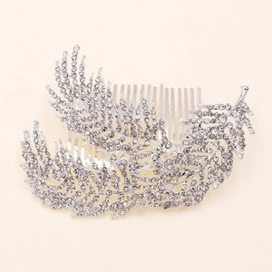 Detailed view of silver bridal hair comb with shimmering leaf shapes and inlaid rhinestones