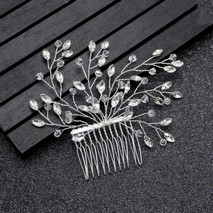 Close-up of silver crystal bridal hair comb with handmade wire-wrapped leaf design