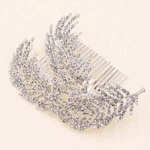 Detailed view of silver leaf bridal hair comb with shimmering rhinestones and metal tines