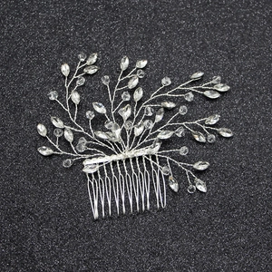 Silver bridal hair comb with handmade glass crystals and rhinestones on a dark background
