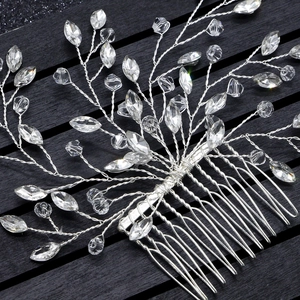 Close-up of handmade bridal hair comb with sparkling crystals and silver wire details