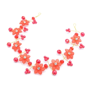 Detail view of handcrafted red floral bridal headband with gold wires and crystal beads