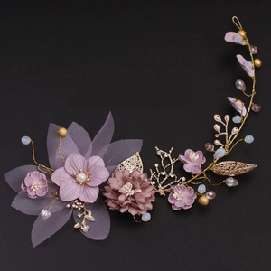 Handmade bridal headpiece with purple fabric flowers and golden metallic leaves