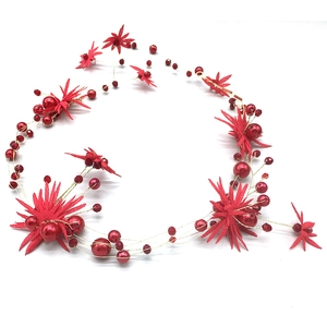 Detailed close-up of handmade bridal floral hair vine with red pearls and golden wire
