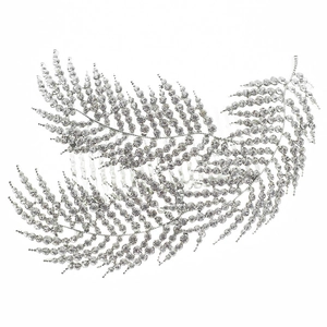 Detail of silver leaf hair comb with sparkling rhinestones for bridal hairstyle