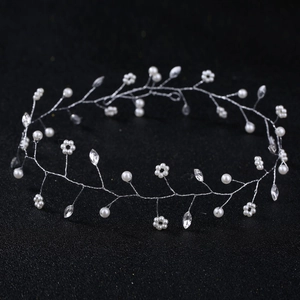 Macro detail of bridal hair vine with silver wire, white pearls and sparkling crystals