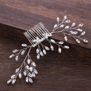 Detailed macro view of silver bridal hair comb with marquise rhinestones and wire branches