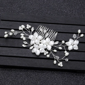 Detail showing bridal hair comb with handmade pearls, crystals and white flowers
