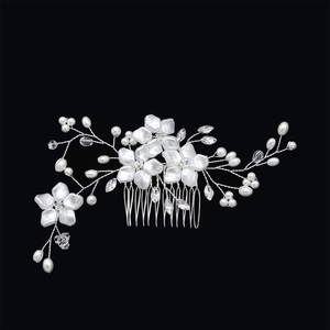 Detailed macro of handcrafted bridal hair comb with pearls and crystal flowers