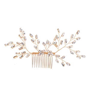 Golden bridal hair comb with rhinestone leaf design and metallic wired branches for weddings