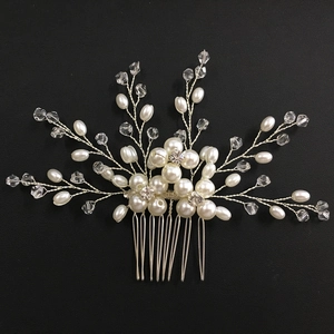 Macro shot of silver bridal hair comb with pearls and multifaceted crystal beads