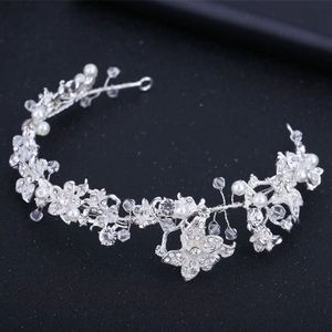 Detailed macro view of handmade silver bridal headband with pearls and crystal rhinestones