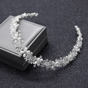 Vista dettagliata della fascia da sposa con strass, perle e motivi floreali in argento