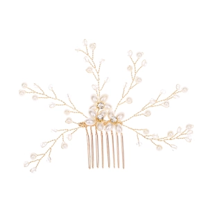 Detailed view of handmade bridal hair comb with gold wire, white pearls and clear crystals