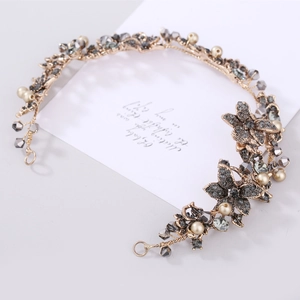 Baroque bridal headpiece with black crystals, cream pearls, and gold alloy floral chain