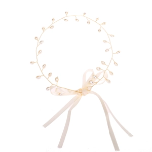 Elegant pearl hairband with golden wire and a soft silk bow for bridal wedding hair